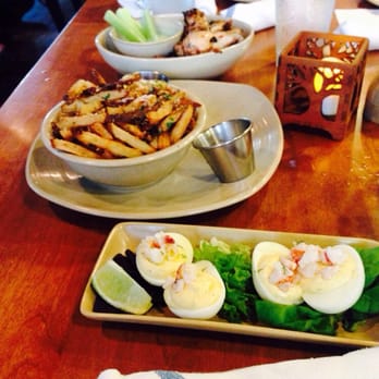 Monkeypod Kitchen - All three starters, the wings up top, in the middle are the garlic truffle fries followed by the lobster deviled eggs. - Hawaiian Near Me - Kapolei, Hawaii