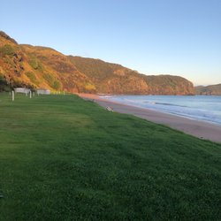 Tauranga Bay Camping - Grassy campsites right on the edge of the beach