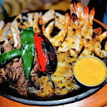 Lupe Tortilla Mexican Restaurant - The Trío - beef, chicken, and shrimp with steak butter and peppers and grilled onions - Tex-Mex Near Me - Cypress, Texas