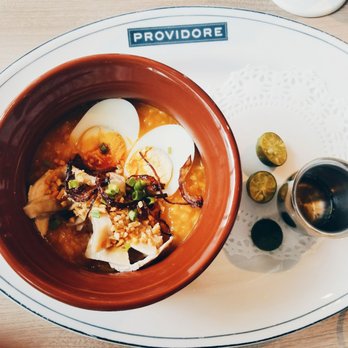 Providore - Arroz Caldo. Side of vinegar and calamansi. Topped with egg and pieces of peanuts. - Cafes Near Me - Taguig, NCR Providore - Arroz Caldo. Side of vinegar and calamansi. Topped with egg and pieces of peanuts. - Cafes Near Me - Taguig, NCR