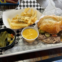 Beef and cheddar croissant, sweet and hot peppers, crinkle cut fries, and cheese sauce Beef and cheddar croissant, sweet and hot peppers, crinkle cut fries, and cheese sauce
