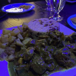 Reggae Fusion - Curried goat in the restaurant's lighting. My first thought was that the curry looked "toxic"