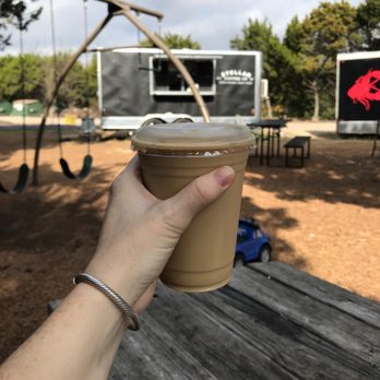 Thicket Food Park - a hand holding a cup of iced coffee - Food Trucks Near Me - Austin, Texas Thicket Food Park - a hand holding a cup of iced coffee - Food Trucks Near Me - Austin, Texas