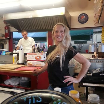 Trackside Grill - a woman standing in a kitchen - New American Near Me - Saratoga Springs, New York Trackside Grill - a woman standing in a kitchen - New American Near Me - Saratoga Springs, New York