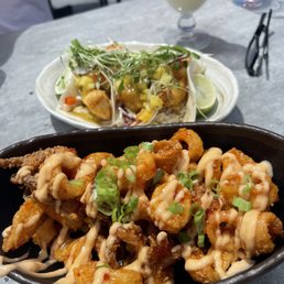 a bowl of food and a plate of salad
