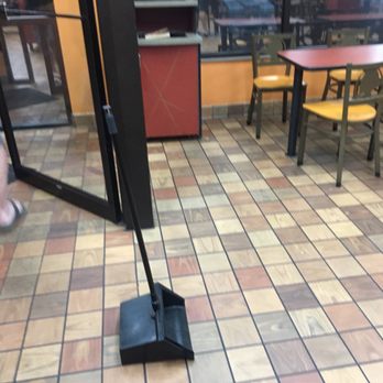 Taco Bell - Dust pan just left by worker who went to do something else - Fast Food Near Me - Ludington, Michigan