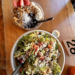 a bowl of salad and a bowl of fruit a bowl of salad and a bowl of fruit