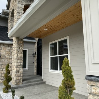 Sole Source Construction - Pine-wood soffit stained, hardie plank siding, cedar-wood trim, exposed-aggregate concrete entrance, Snow White pebble stones - General Contractors Near Me Sole Source Construction - Pine-wood soffit stained, hardie plank siding, cedar-wood trim, exposed-aggregate concrete entrance, Snow White pebble stones - General Contractors Near Me