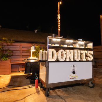 Dazzling Donuts - a donut stand lit up at night - Caterers Near Me