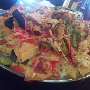 Saddle Ranch - During Happy Hour, this mountain of Grilled Chicken Nachos is only $7.50. - Steakhouses Near Me - Orange, California Saddle Ranch - During Happy Hour, this mountain of Grilled Chicken Nachos is only $7.50. - Steakhouses Near Me - Orange, California