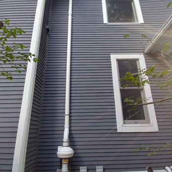 Clean Air Radon Systems - White fan and  PVC to match white trim hidden on side of house. - Environmental Abatement Near Me