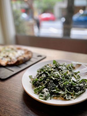 Photo of Serious Pie Downtown - Seattle, WA, US. Marinated Lacinato Kale, Parmesan, Calabrian Chilies, Pine Nuts (half eaten)