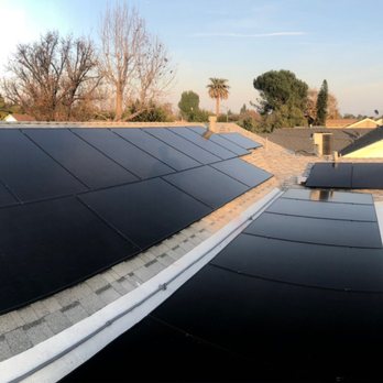 Jovic Construction - All shingles 3D grey color as you can see in the foreground. Solar boxes & pipes painted to match roof! - Solar Installation Near Me