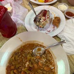Waterfront - Gumbo, baked potato, part of a "crab roll" next to the potato