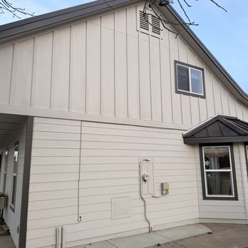 Flooded Timber Construction - A two-story house with beige siding, a small window on the upper level, and a bay window on the lower level, with an overcast sky. - General Contractors Near Me - Rocklin, California