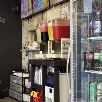 La Guera Street Tacos - The front counter where you pay and order and their aguas frescas (fresh juice) and cooler stocked with other drink options - Mexican Near Me - Arlington, Texas
