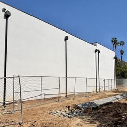 Rio Rico Seamless Rain Gutters - Sleek New Modern Home Featuring Black Aluminum Seamless Rain Gutters with Premium Gutter Guards and Industrial-Style Leader Heads