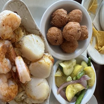 Waterman's Surfside Grille - Just seafood with jumbo shrimp scampi, scallops and crab meat with lemon, butter white wine and old bay seasoning. Hush puppies - Bars Near Me - Virginia Beach, Virginia Waterman's Surfside Grille - Just seafood with jumbo shrimp scampi, scallops and crab meat with lemon, butter white wine and old bay seasoning. Hush puppies - Bars Near Me - Virginia Beach, Virginia