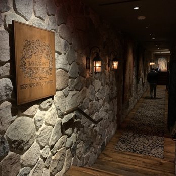 The Immigrant Restaurant - a stone wall with a plaque on it - New American Near Me - Kohler, Wisconsin The Immigrant Restaurant - a stone wall with a plaque on it - New American Near Me - Kohler, Wisconsin