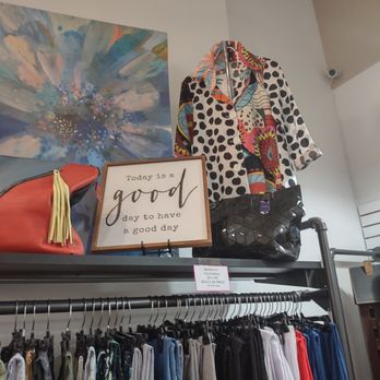 Razberry Threads - Women's clothing racks and display of colorful jacket and pocketbook with wooden sign - Women's Clothing Near Me - Hendersonville, North Carolina