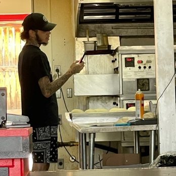 Stoner's Pizza Joint - Guy Making the Dough checking his dirty phone every minute and then going back to touching the dough without washing his hands. - Pizza Near Me - Denver, Colorado