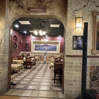 Napolinos - the entrance to a restaurant with tables and chairs - Italian Near Me - Wildwood, Florida Napolinos - the entrance to a restaurant with tables and chairs - Italian Near Me - Wildwood, Florida