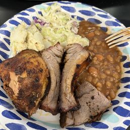 a plate of meat, beans, and coleslaw a plate of meat, beans, and coleslaw