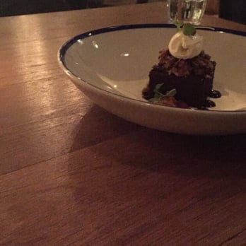 Byblos - dessert as described on their menu: CHOCOLATE MOUSSE Broken Pinenut Baklava + Whipped Labneh + Date Molasses + Pomegranate - Mediterranean Near Me - Toronto, Ontario