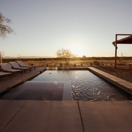 the sun setting over the pool