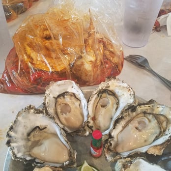 Crawfish King - Grilled Oysters (bottom) and bag where they serve the one pound of Crawfish and Crab in House Special Sauce (top) - Cajun/Creole Near Me - Seattle, Washington