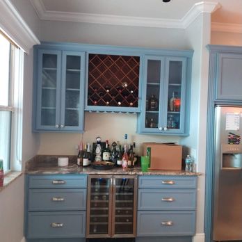 Bespoke Renovation - Wood cabinets updated with beautiful blue color to contrast with orange granite countertops, - Painters Near Me Bespoke Renovation - Wood cabinets updated with beautiful blue color to contrast with orange granite countertops, - Painters Near Me