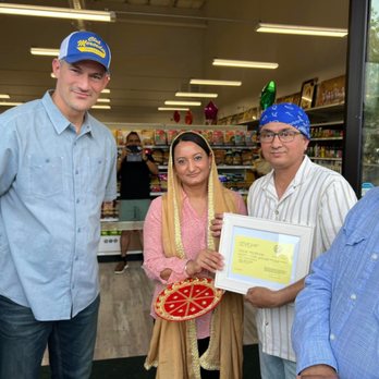 Merced Indian Grocers - a man holding a pizza - Grocery Near Me - Merced, California Merced Indian Grocers - a man holding a pizza - Grocery Near Me - Merced, California