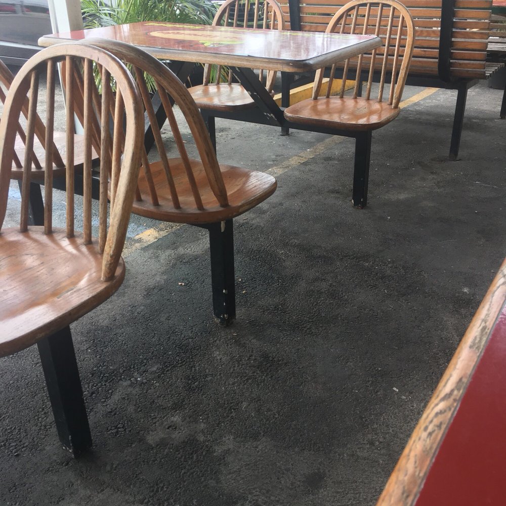La Granja - a table and chairs in a restaurant - Peruvian Near Me - Miami, Florida