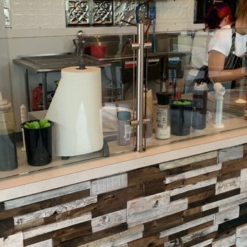 Roll Shack - a woman behind the counter preparing food - Ice Cream & Frozen Yogurt Near Me - Abilene, Texas