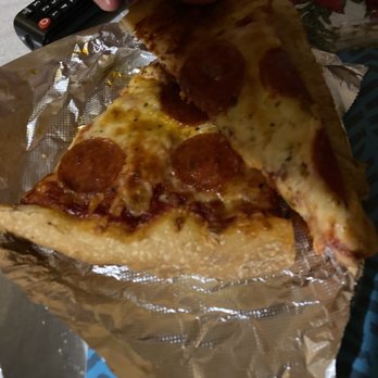 Mary's Deli - My cold soggy pizza from Mary Deli 0 - A slice of pepperoni pizza with melted cheese and pepperoni slices is being lifted from a foil-lined pizza box. - Pizza Near Me - Dunkirk, New York