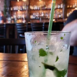 a mojit in a glass with a straw a mojit in a glass with a straw