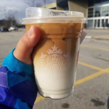 Starbucks - a hand holding a cup of iced coffee - Coffee & Tea Near Me - Mississauga, Ontario Starbucks - a hand holding a cup of iced coffee - Coffee & Tea Near Me - Mississauga, Ontario