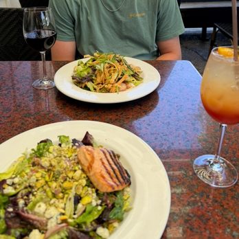 Los Olivos Cafe - Foreground: Little Gem Salad with Salmon ($34) with a Summer Spritz ($18) Background: Asian Chicken Salad ($20) with a Cab ($15) - New American Near Me - Los Olivos, California Los Olivos Cafe - Foreground: Little Gem Salad with Salmon ($34) with a Summer Spritz ($18) Background: Asian Chicken Salad ($20) with a Cab ($15) - New American Near Me - Los Olivos, California