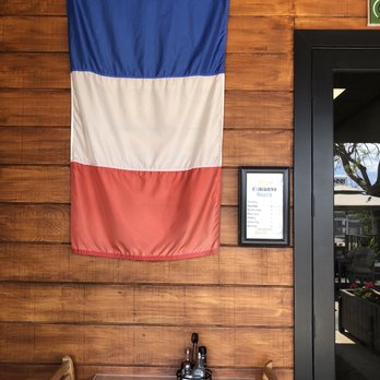La Parisienne Bakery - French flag and hours at entrance - Bakeries Near Me - North Miami Beach, Florida
