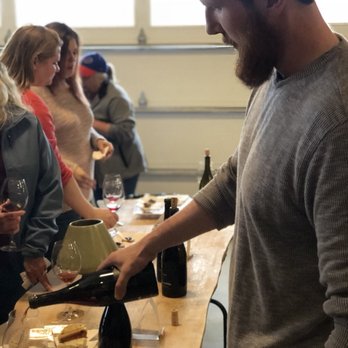 Liten Buffel - Co-owner Pat Vaughn pouring for tasters. - Wine Tasting Room Near Me - Middleport, New York