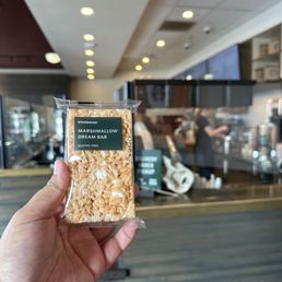 a hand holding a bag of popcorn