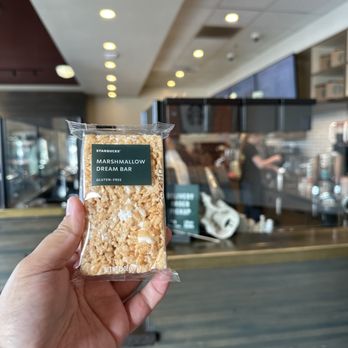 Starbucks - a hand holding a bag of popcorn - Coffee & Tea Near Me - Orange, California