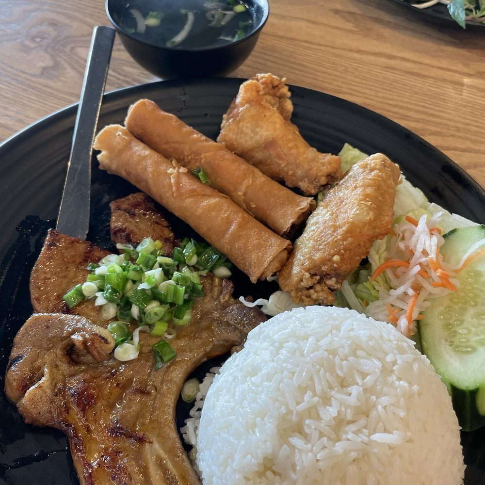 Pho 99 - R1. Grilled Pork Chop, Fried Chicken Wing and Egg Roll over Rice Combo Plate - Vietnamese Near Me - Fremont, California Pho 99 - R1. Grilled Pork Chop, Fried Chicken Wing and Egg Roll over Rice Combo Plate - Vietnamese Near Me - Fremont, California