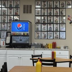 Beverage station with photos of happy patrons