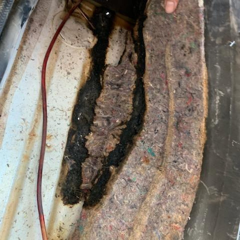 Holes burned through the floorpan