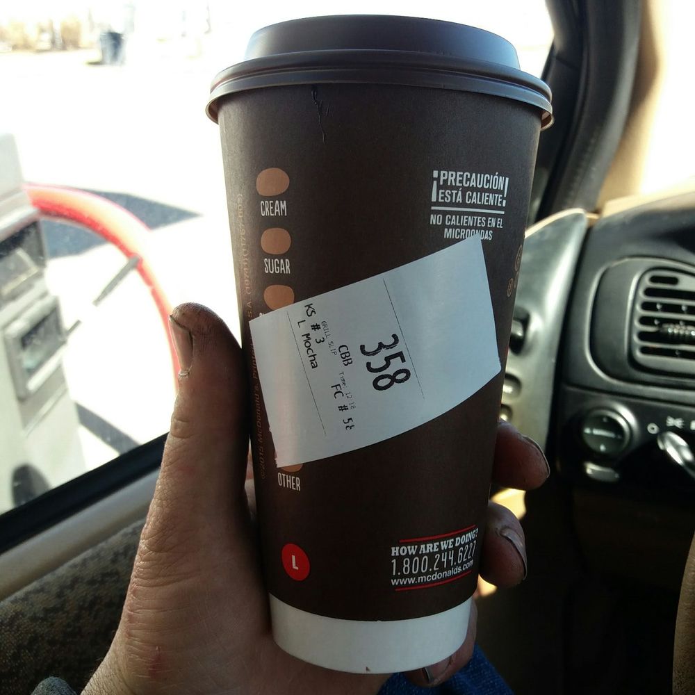 a person holding a cup of coffee