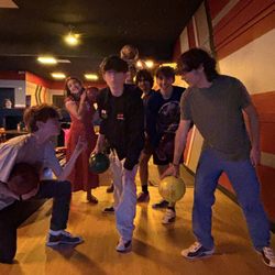 Kids having a fun time bowling.