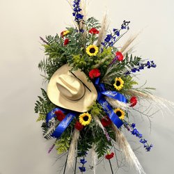 Floral Defined - Custom sympathy floral standing spray on an easel with country western/cowboy theme.