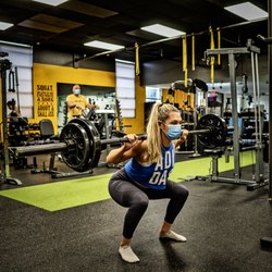 UTG Personal Training - Bergen County NJ - Client perfecting a barbell squat with complete range of motion
