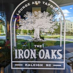 The Iron Oaks - Outside. The Iron Oaks storefront logo. Located at Glenwood Place. Free deck parking on-site.